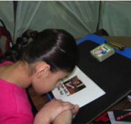 Student looks at pictures in a book.