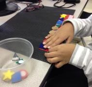 pictures shows student matching tactile shapes on a Velcro strip