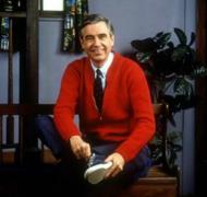 Mr. Rogers wearing a red cardigan