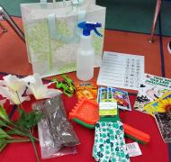 “Story Box for Spring” including books and objects such as gloves, rakes, water bottles, picture cards for pages of the book