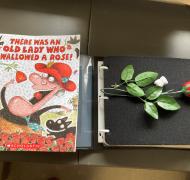 Book: There was an old lady that swallowed a rose with an APH book builder book and a plastic rose