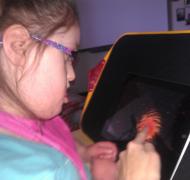 Girl with glasses uses iPad