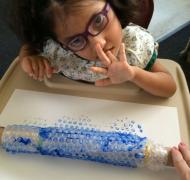 Girl doing bubble wrap painting