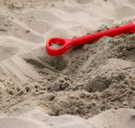 Plastic bucket and shovel on beach