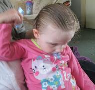 young girl combing her hair