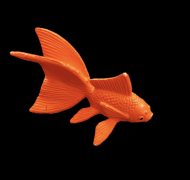 Toy goldfish against black background