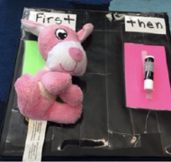 First/then schedule with pink stuffed animal and chapstick