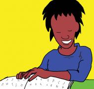 Smiling broadly, student uses both hands to look at a braille book.
