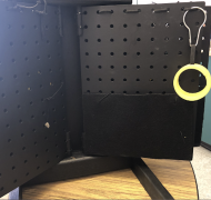 Black pegboard book with yellow slinky