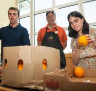 Two students examine oranges