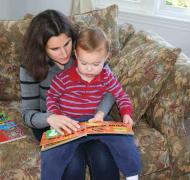 A mother who is blind reads a book with her sighted child