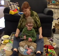 Adult seated with child on Resonance Board