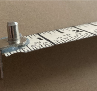 Ruler with L-shaped support peg