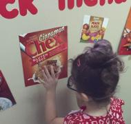Child choosing Chex from snack menu wall