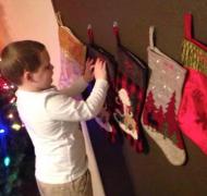 Boy reads braille on his Christmas stocking