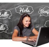 Teen student on laptop with chalkboard background saying hello in various languages
