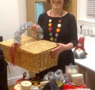 woman holding basket over table of christmas items