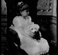Helen Keller as a young girl with her dog on her lap