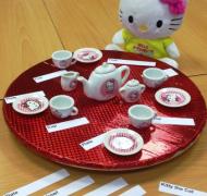Stuffed kitty with tea party and braille labels