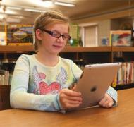 Girl reading large print on iPad