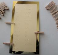 card with braille words and clothespins with contractions