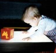 Toddler explores the surface of a light box