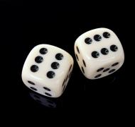 two dice on a black surface