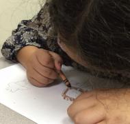 Student drawing a thank you note