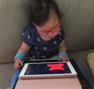 Young girl with iPad on toddler-sized lap desk