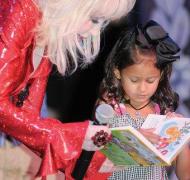 Image of Dolly Parton reading a book with a young girl