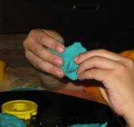 Photo of child's hands manipulating playdoh