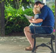 Father reading to young child