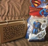 a flip book next to a Superman action figure