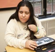 a female student using a braille notetaker