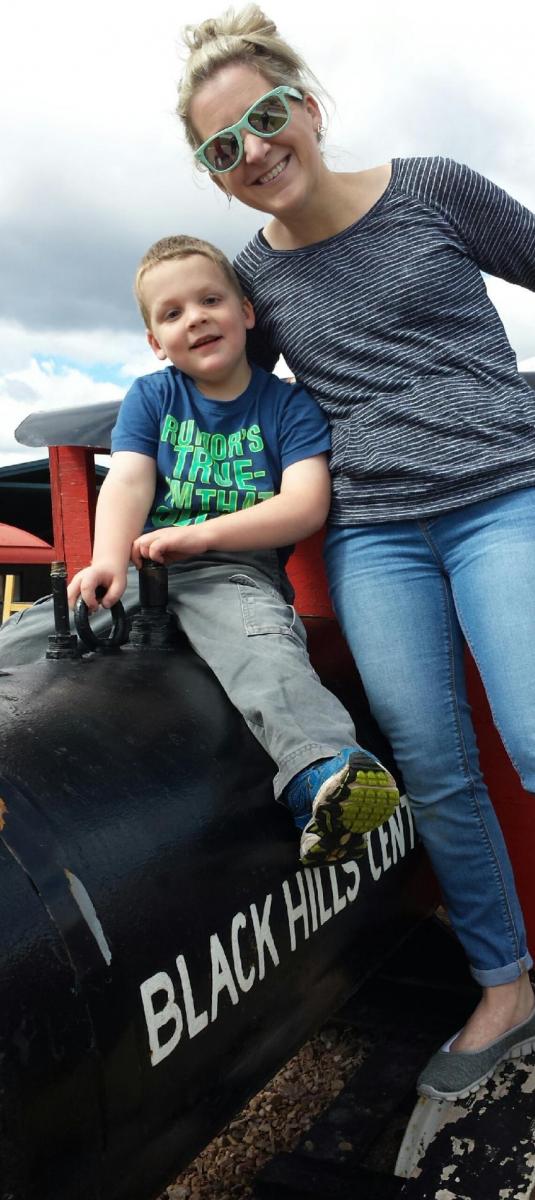 Mother and son sitting on train