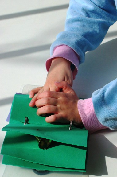 Child touching page of object book