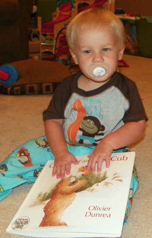 Boy with APH partnership print and braille book