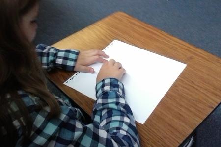 Girl reading braille