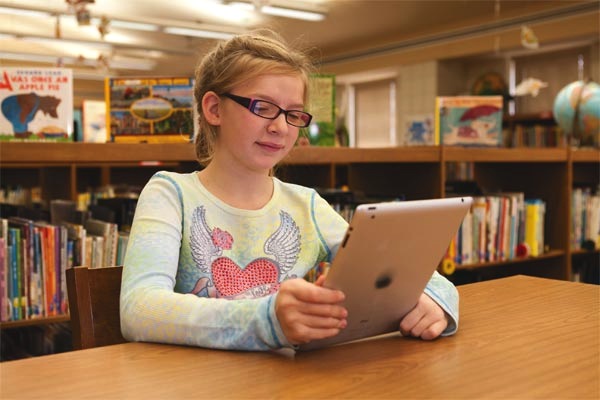 Girl reading large print on iPad
