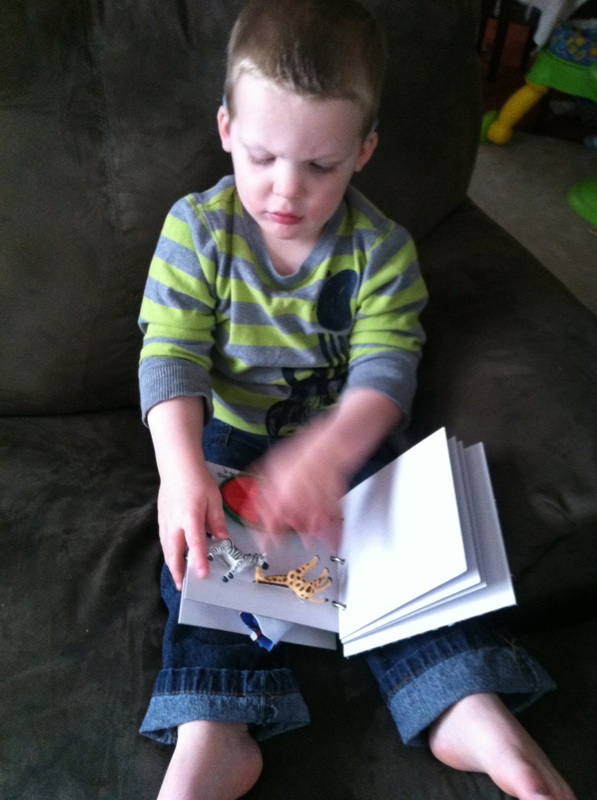 A young boy examines a tactile book.