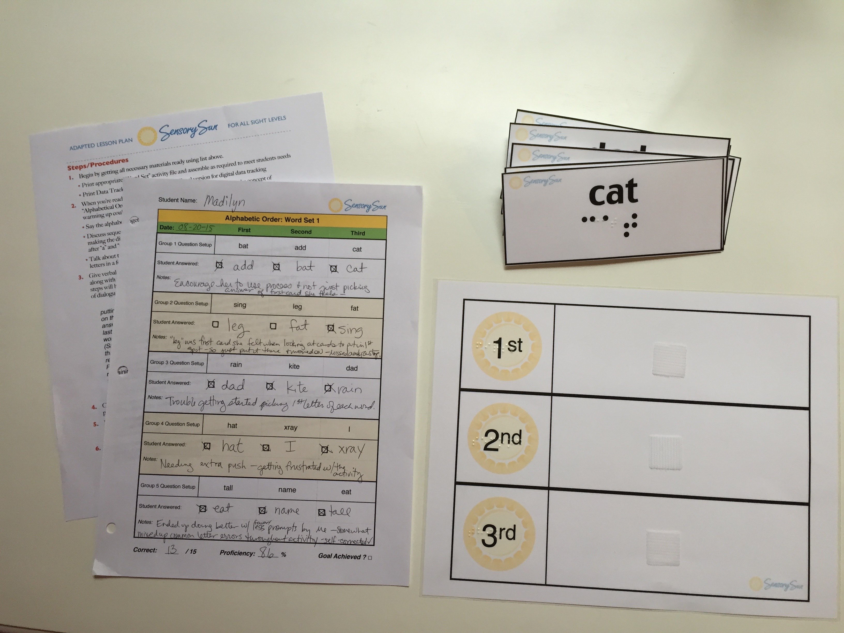 Flashcards with Braille and Printed Lesson Sheets on Desk