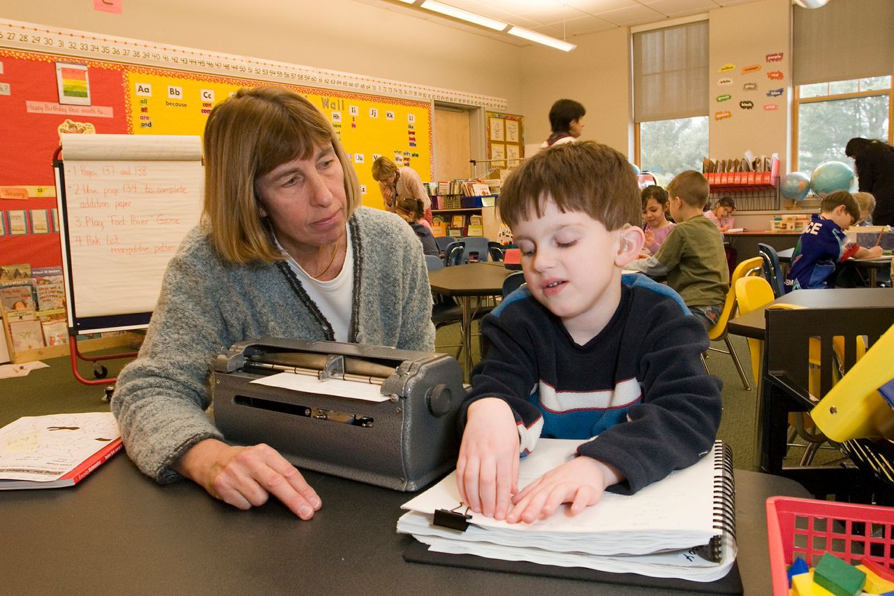 Teacher with braille student