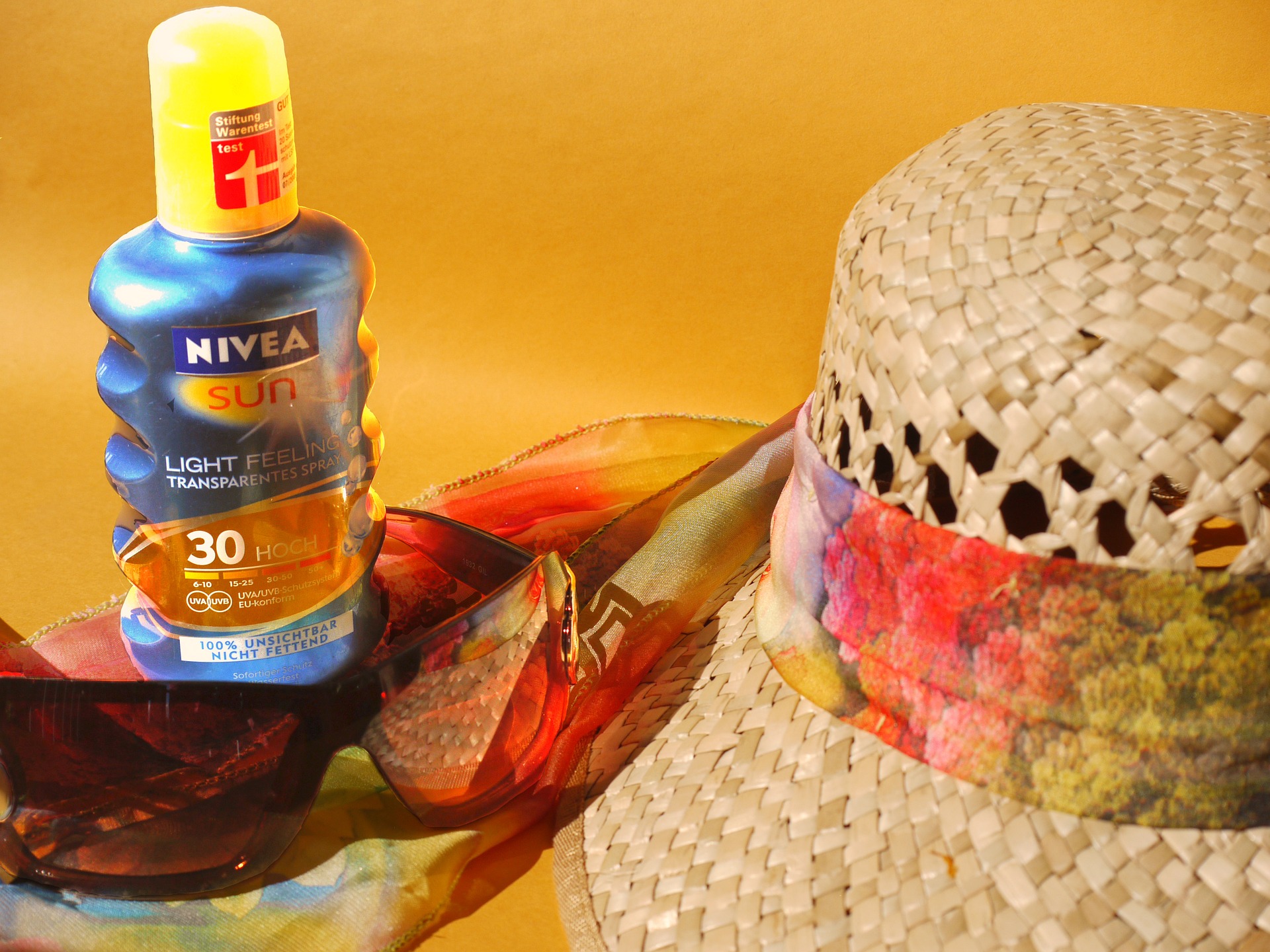 sunscreen, sunglasses, and a straw hat