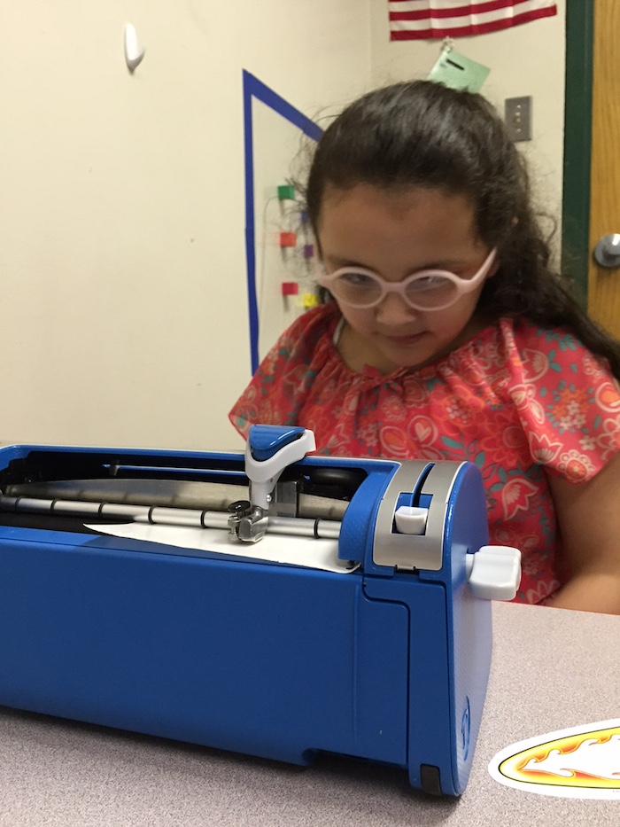 Student using braille writer