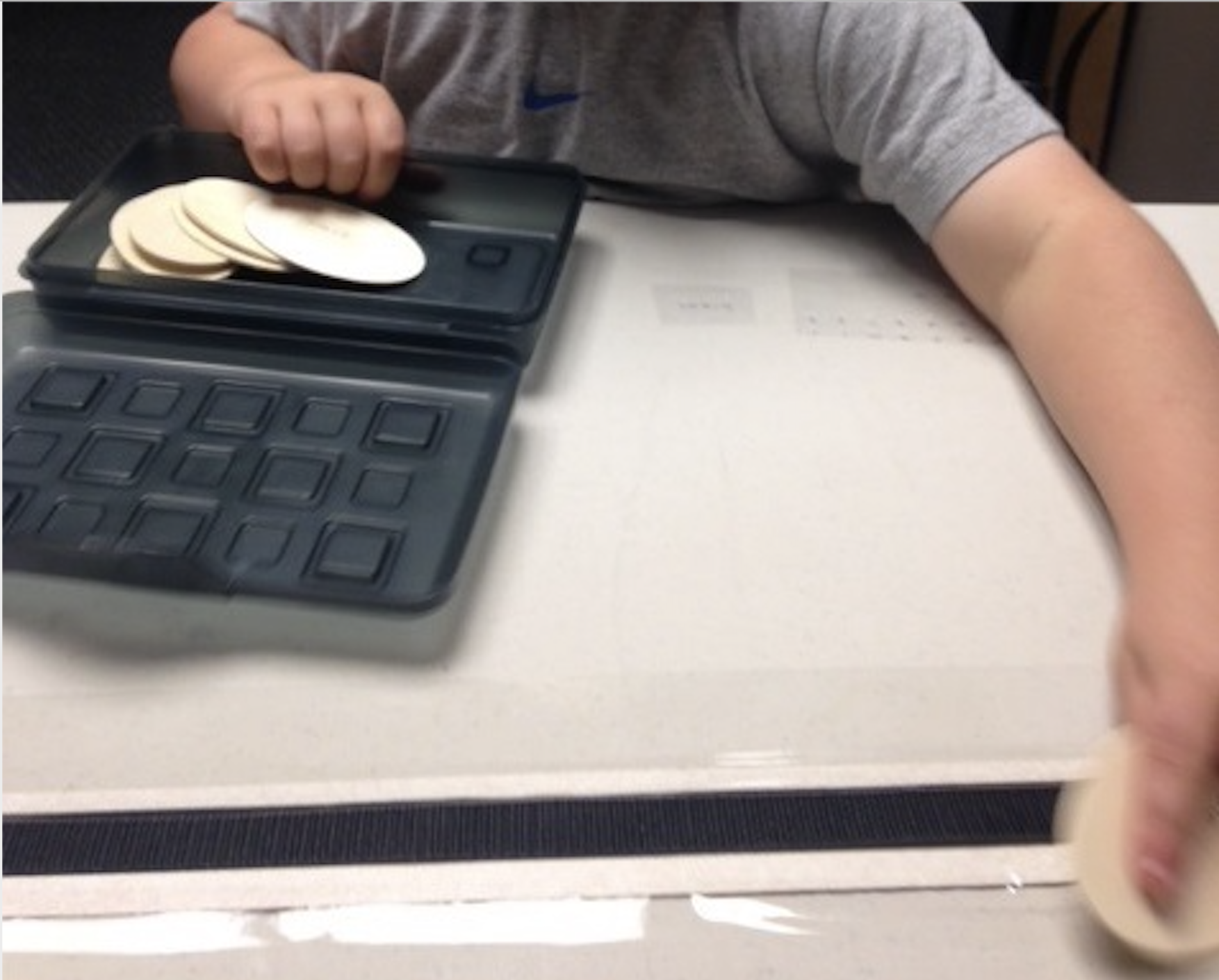 Child placing an activity block on to the desk calendar