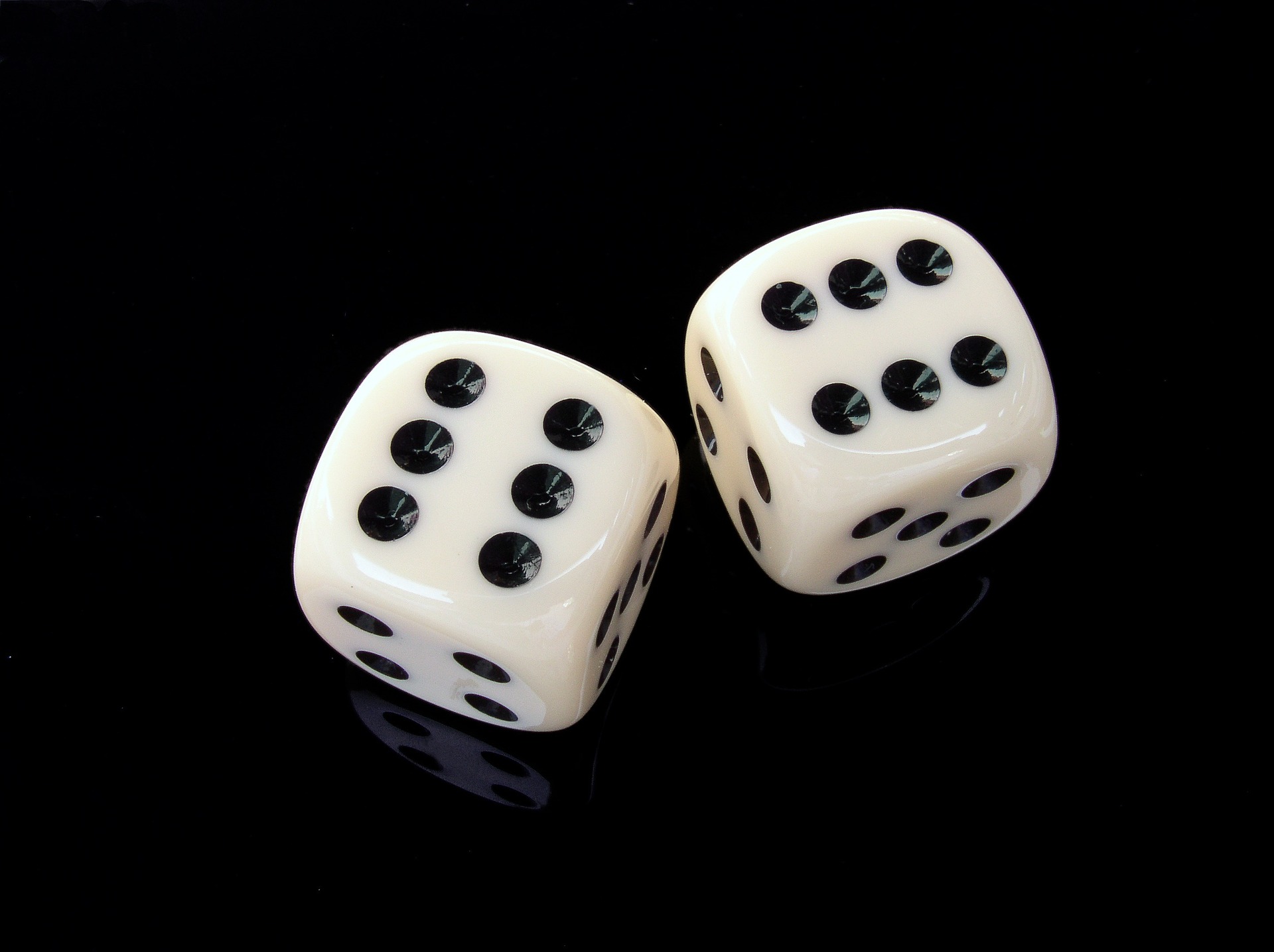 two dice on a black surface