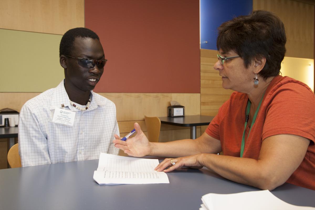 A student working with a teacher.