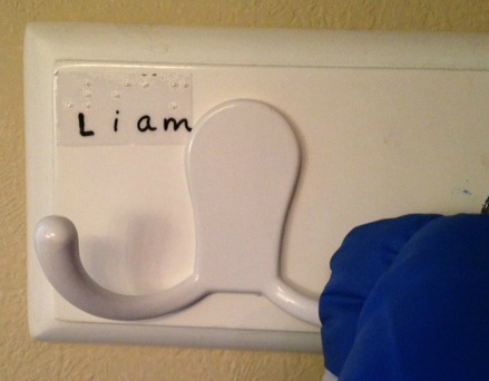 coat hanger with "Liam" label in braille