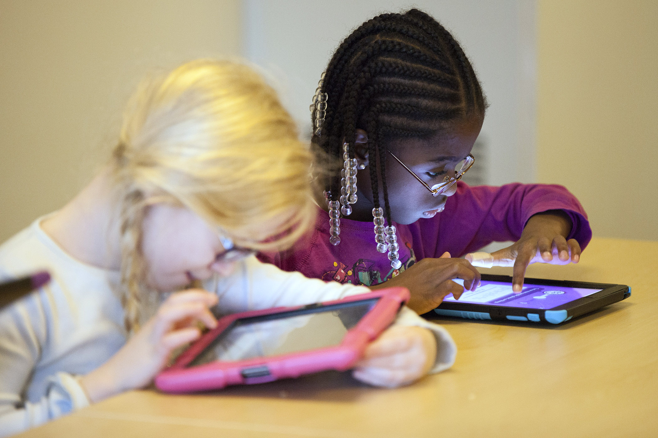 Two girls using iPads
