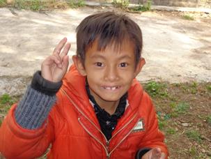 A young girl signs the number "two".